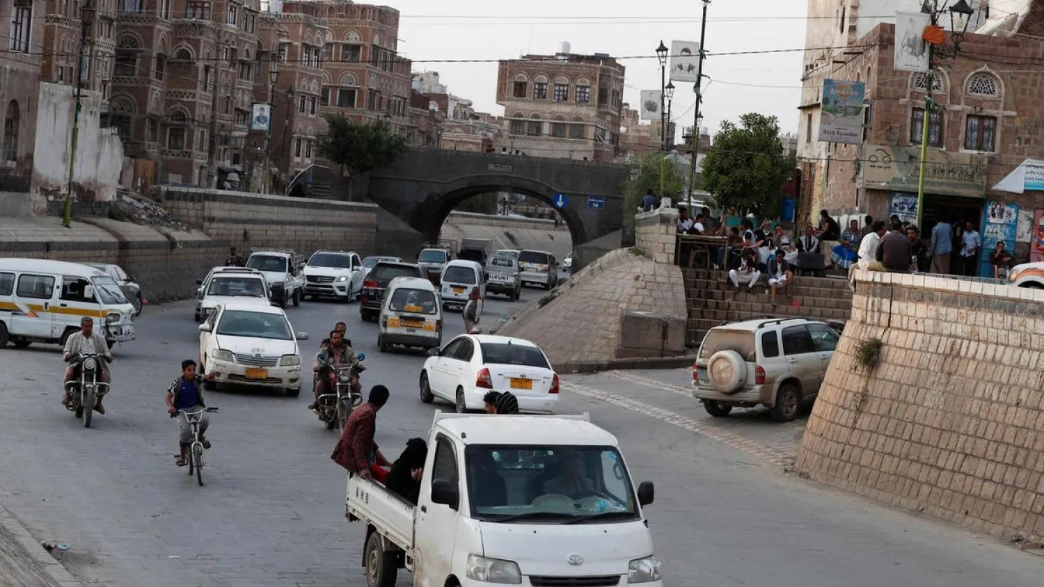 Yemenis drive past historic buildings in the old city of Sanaa, Yemen, September 2020. (EPA)