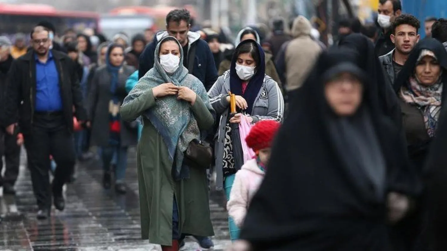 Iranian women wear protective masks to prevent contracting a coronavirus, as they walk at Grand Bazaar in Tehran, Iran, February 20, 2020. (Reuters)
