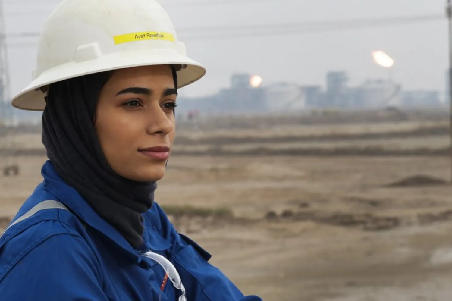 Ayat Rawthan, a petrochemical engineer, poses for a photo near an oil field outside Basra, Iraq, Tuesday, Feb. 5, 2021. (AP Photo/Nabil al-Jourani)
