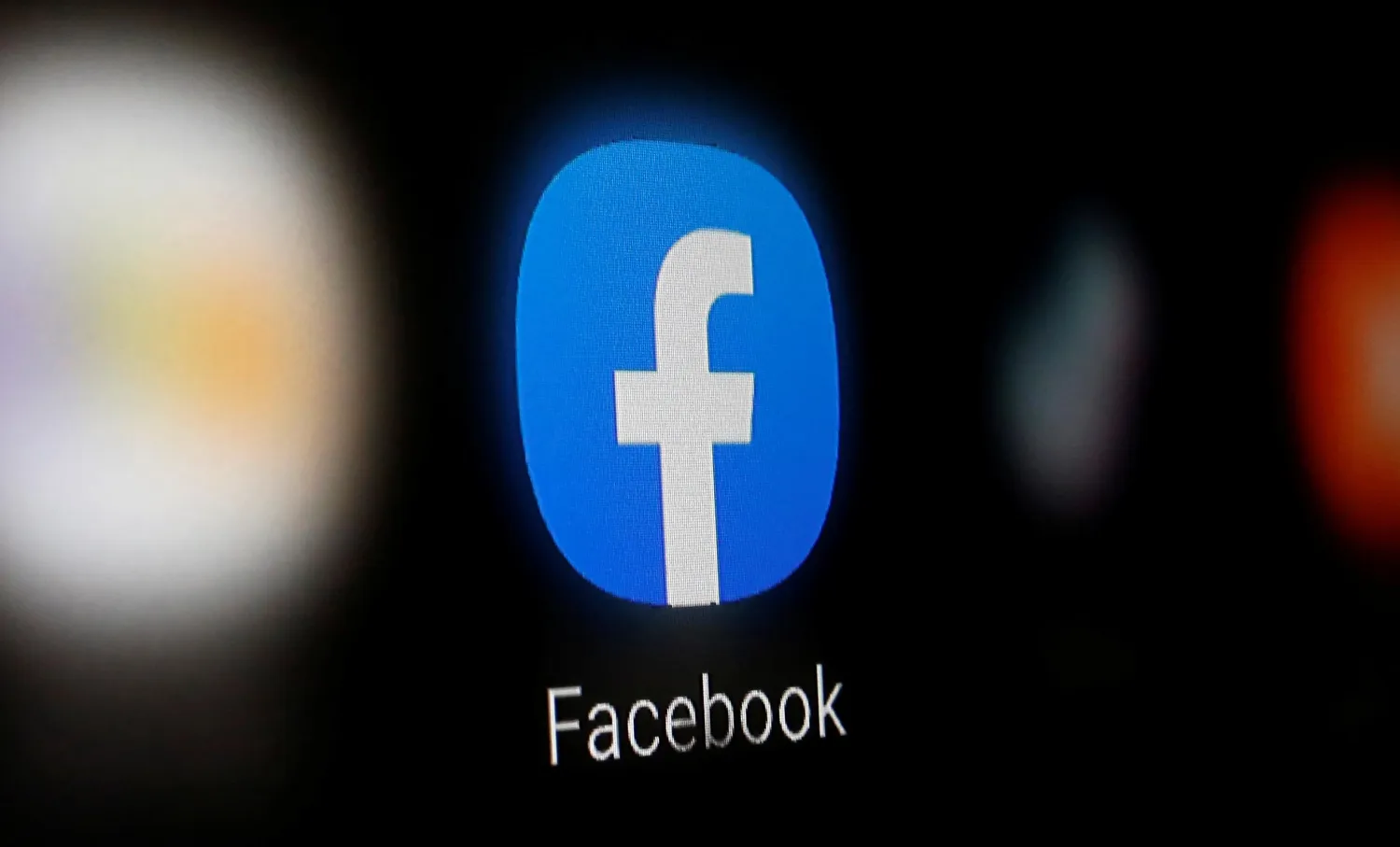 A Facebook logo is displayed on a smartphone. Reuters file photo