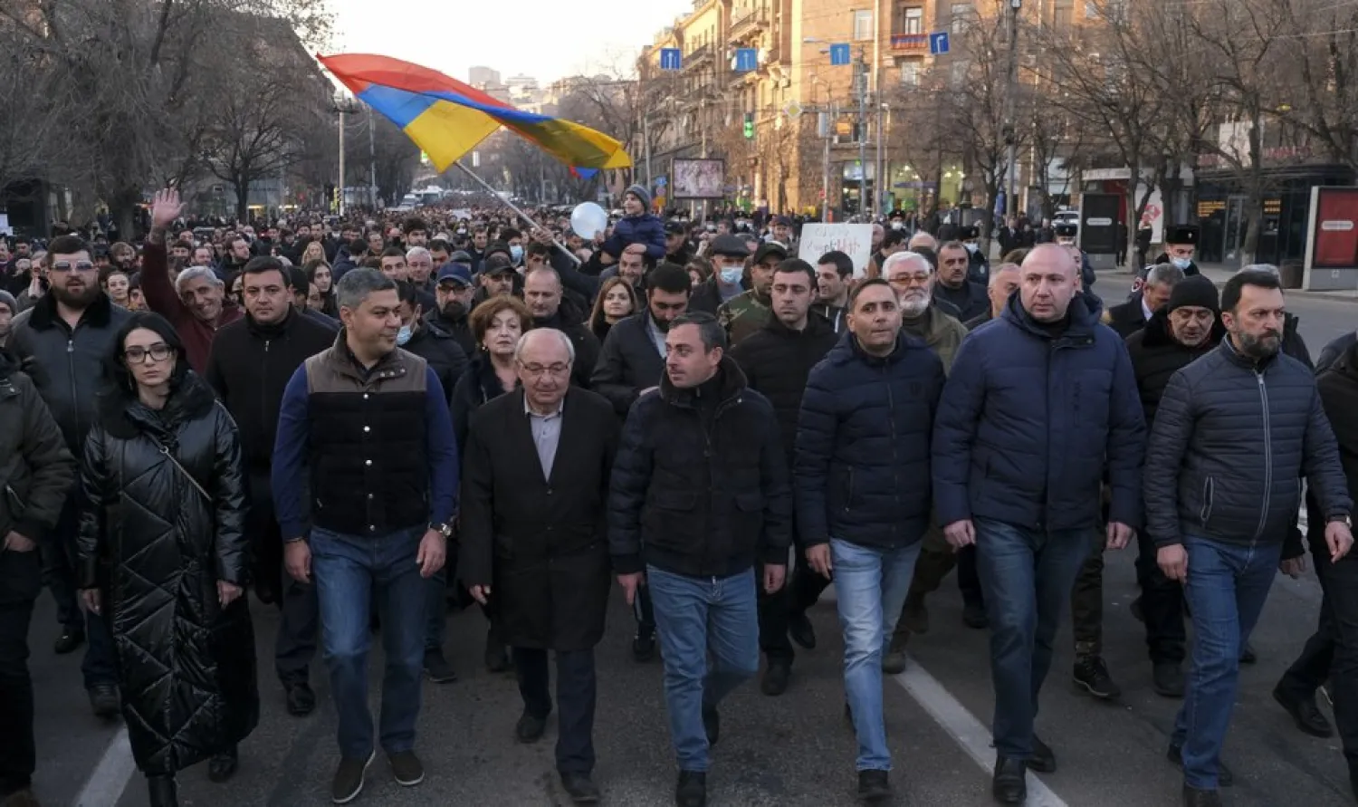 Opposition demonstrators march to the government buildings during a rally to pressure Armenian Prime Minister Nikol Pashinyan to resign in Yerevan, Armenia, Saturday, Feb. 27, 2021. The developments come after months of protests sparked by the nation's defeat in the Nagorno-Karabakh conflict with Azerbaijan. (Hrant Khachatryan/PAN Photo via AP)