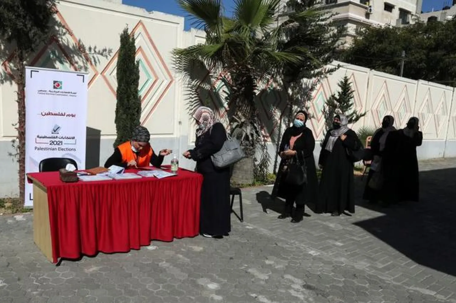 Palestinian women register their names for parliamentary and presidential elections, in a school in Gaza City (Reuters)