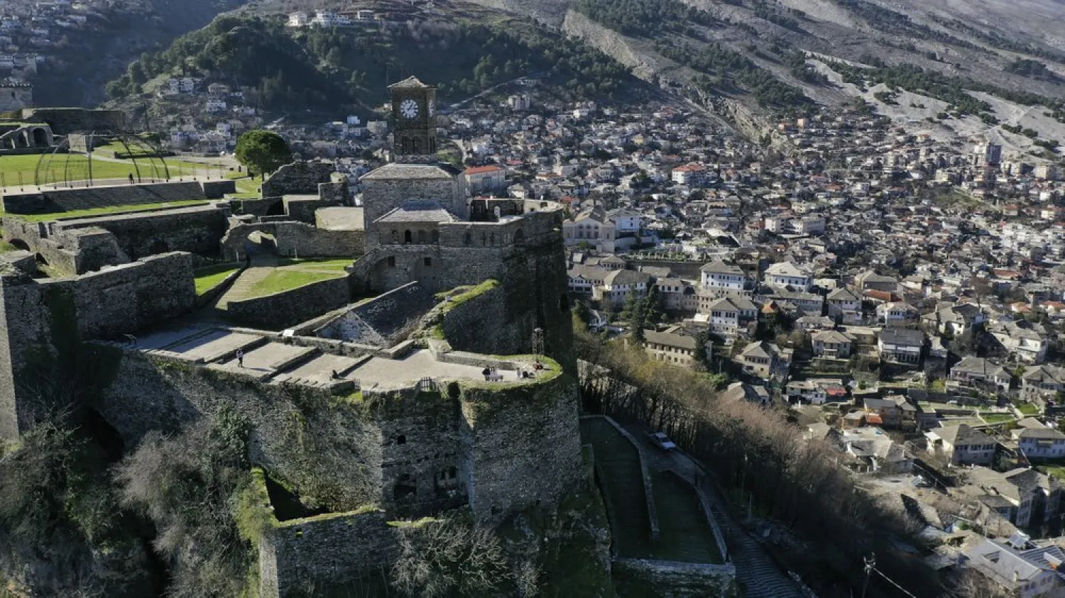 People enjoy the view atop of a castle in Gjirokastra town, southern Albania, Saturday, Feb. 6, 2021. (AP)