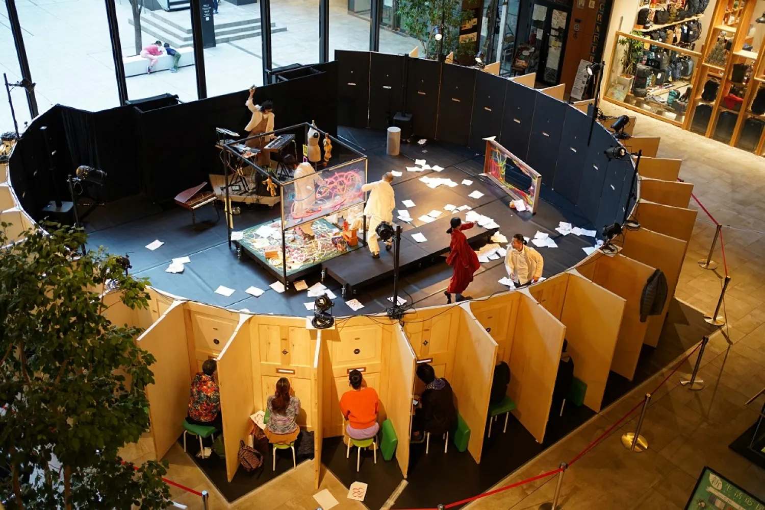 Audience members watch the Moonlight Mobile Theater's dance performance through peepholes at a shopping mall in Nagoya, Japan, February 19, 2021. (Handout via Reuters)
