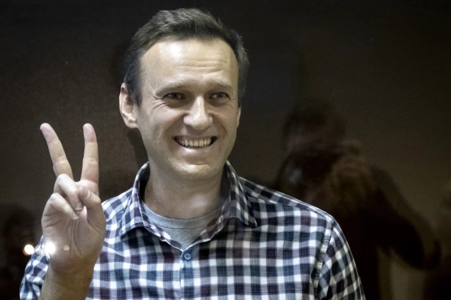 In this Saturday, Feb. 20, 2021 file photo, Russian opposition leader Alexei Navalny gestures as he stands behind a grass of the cage in the Babuskinsky District Court in Moscow, Russia. Russian opposition leader Alexey Navalny was transported to a prison 100km away from Moscow. (AP Photo/Alexander Zemlianichenko, File)