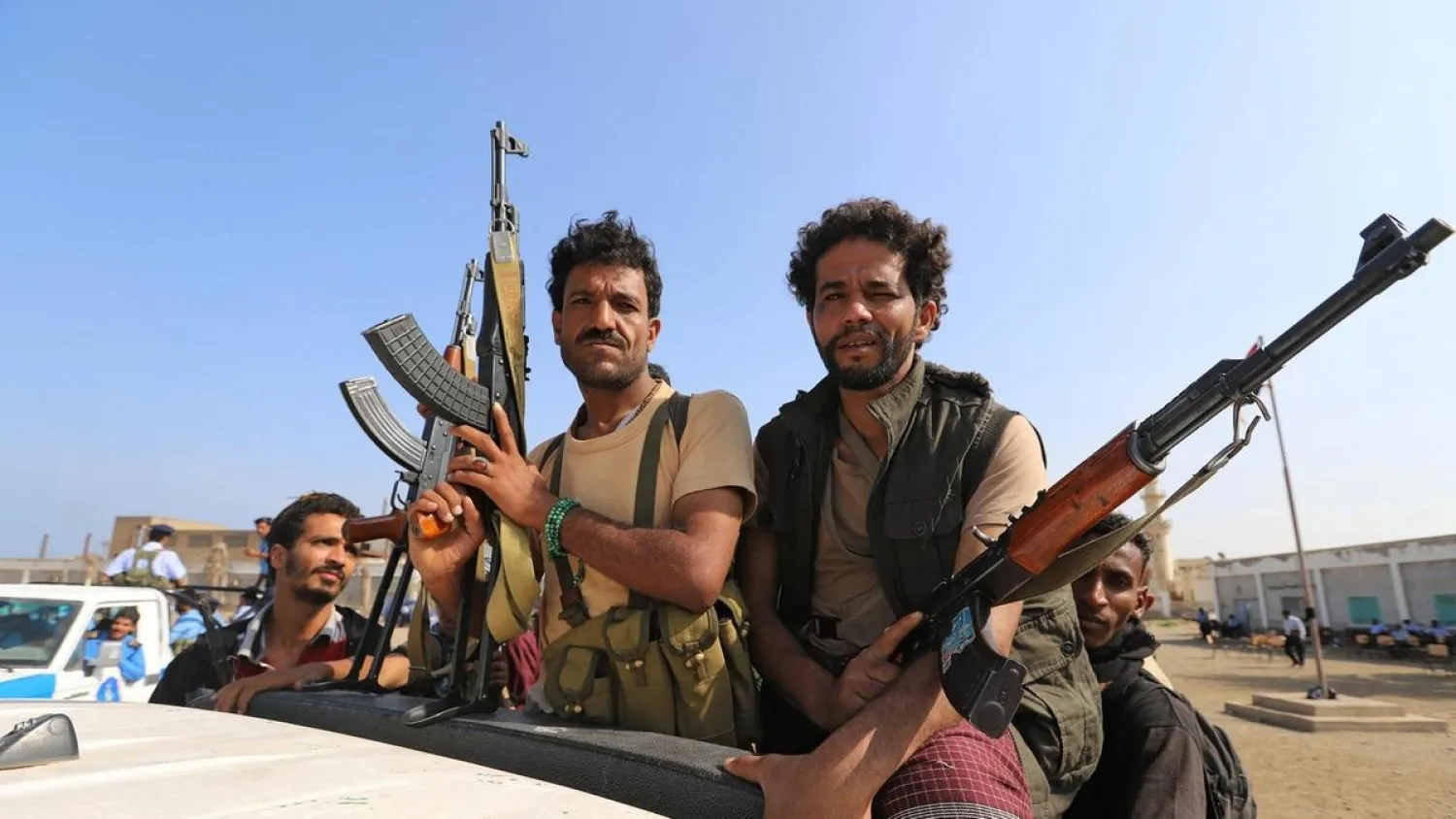 Houthi militants ride on the back of a truck in Hodeidah. (Reuters)