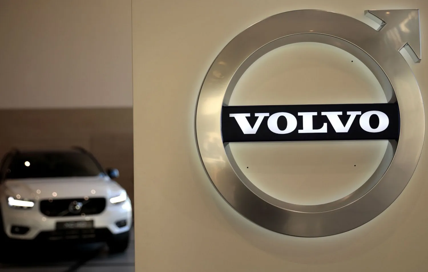 In this Feb. 6, 2020 file photo, a Volvo car is parked behind the Volvo logo in the lobby of the company's corporate headquarters, in Brussels. (AP)
