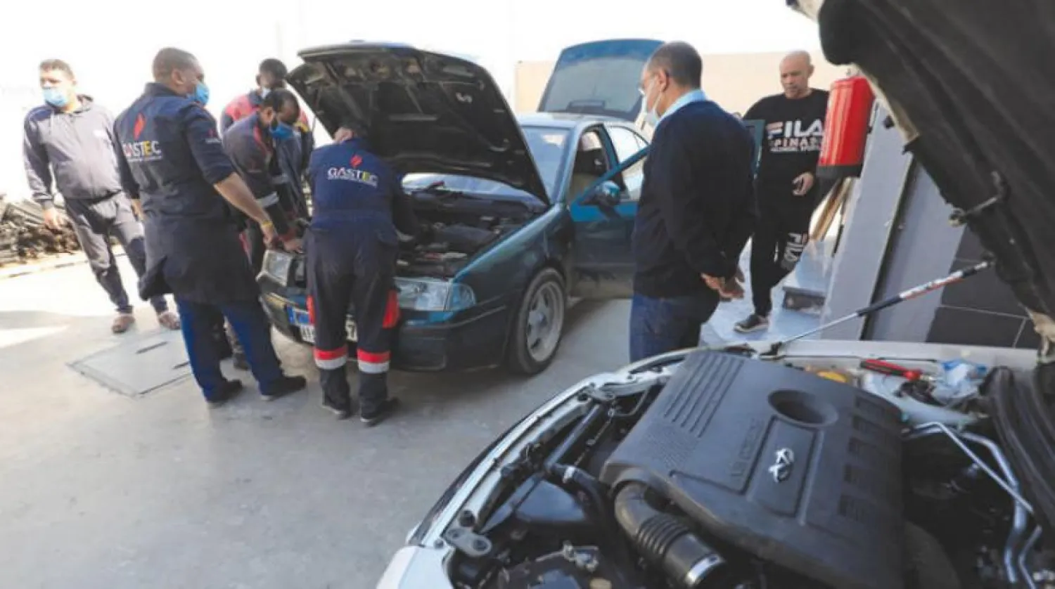 Workers at GasTech Egypt convert a car to run with natural gas. (Reuters)