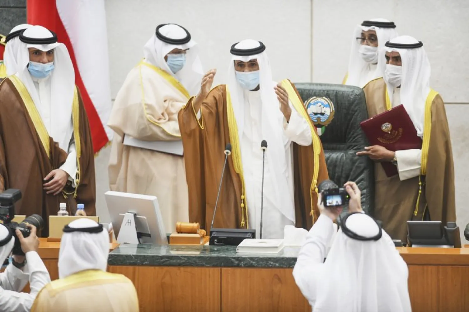 Emir of Kuwait Sheikh Nawaf Al Ahmad Al Sabah, center, performs the constitutional oath at the Kuwaiti National Assembly in Kuwait, Wednesday, Sept. 30, 2020. (AP Photo/Jaber Abdulkhaleg)