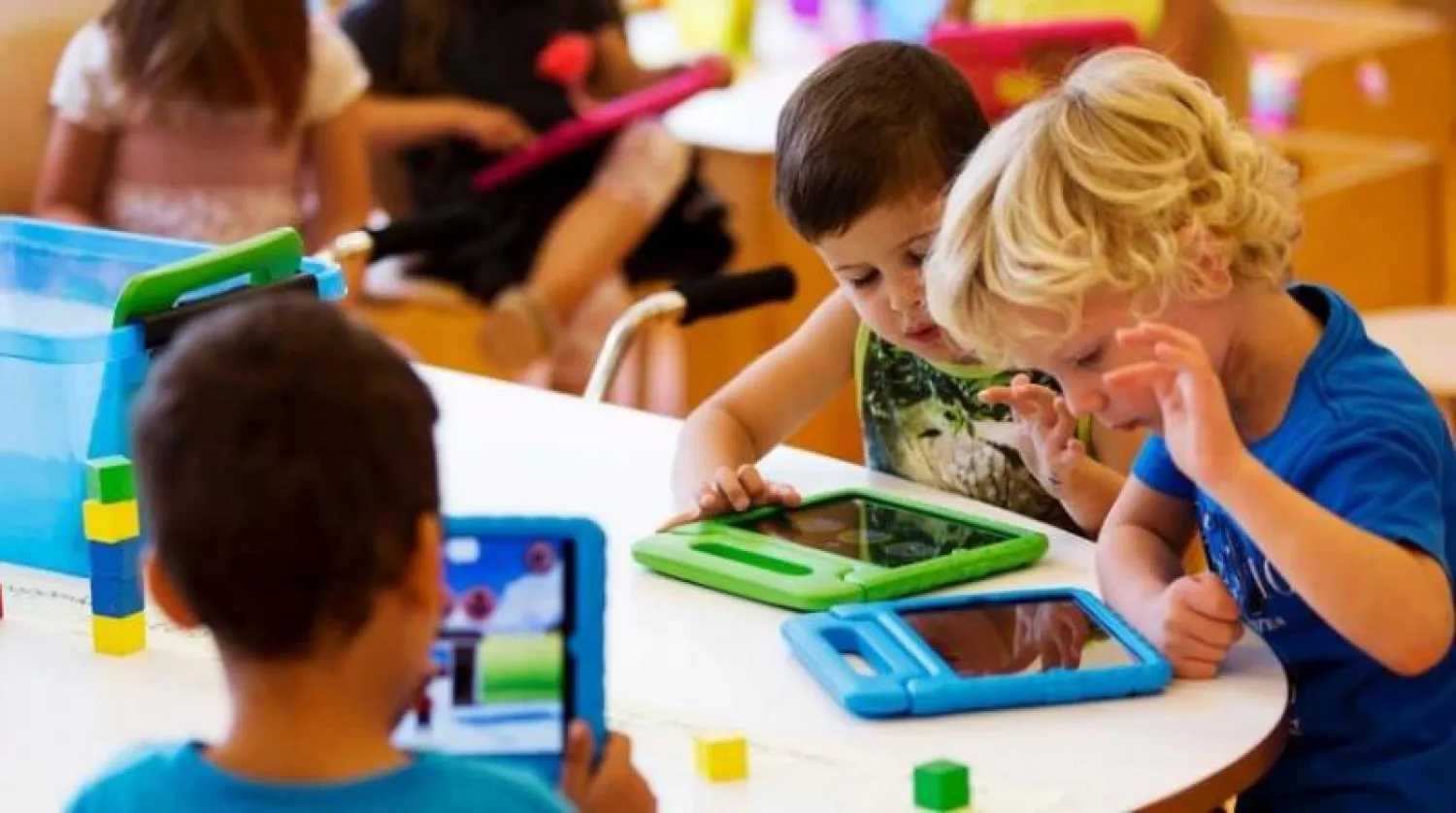 أطفال يستخدمون أجهزة لوحية ذكية (أرشيفية-رويترز)