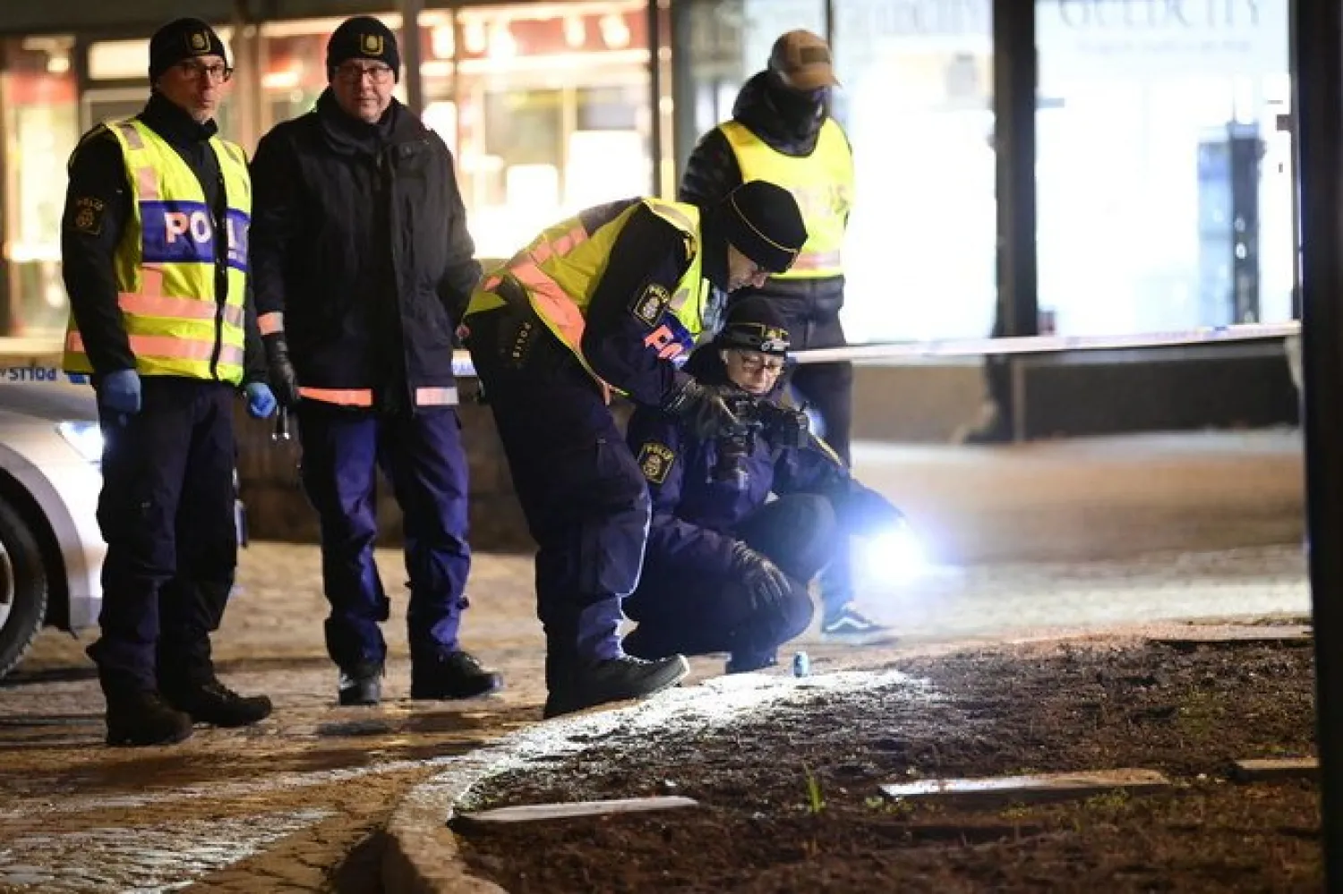 Police scour the area where several people were attacked in Vetlanda, Sweden on March 3, 2021. (TT News Agency via AP)