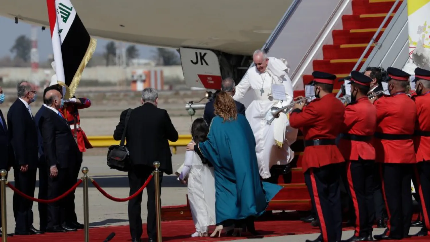 Pope Francis walks down the steps of an airplane as he arrives at Baghdad international airport, Iraq, Friday, March 5, 2021. (AP Photo/Andrew Medichini)