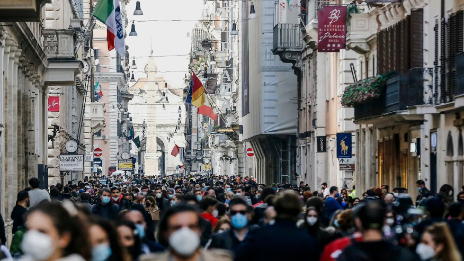 FILE – In this Saturday, Feb. 7, 2021 file photo, people crowd Via del Corso shopping street in Rome, following the ease of restriction measures to curb the spread of COVID-19.  (Cecilia Fabiano/LaPresse via AP)

