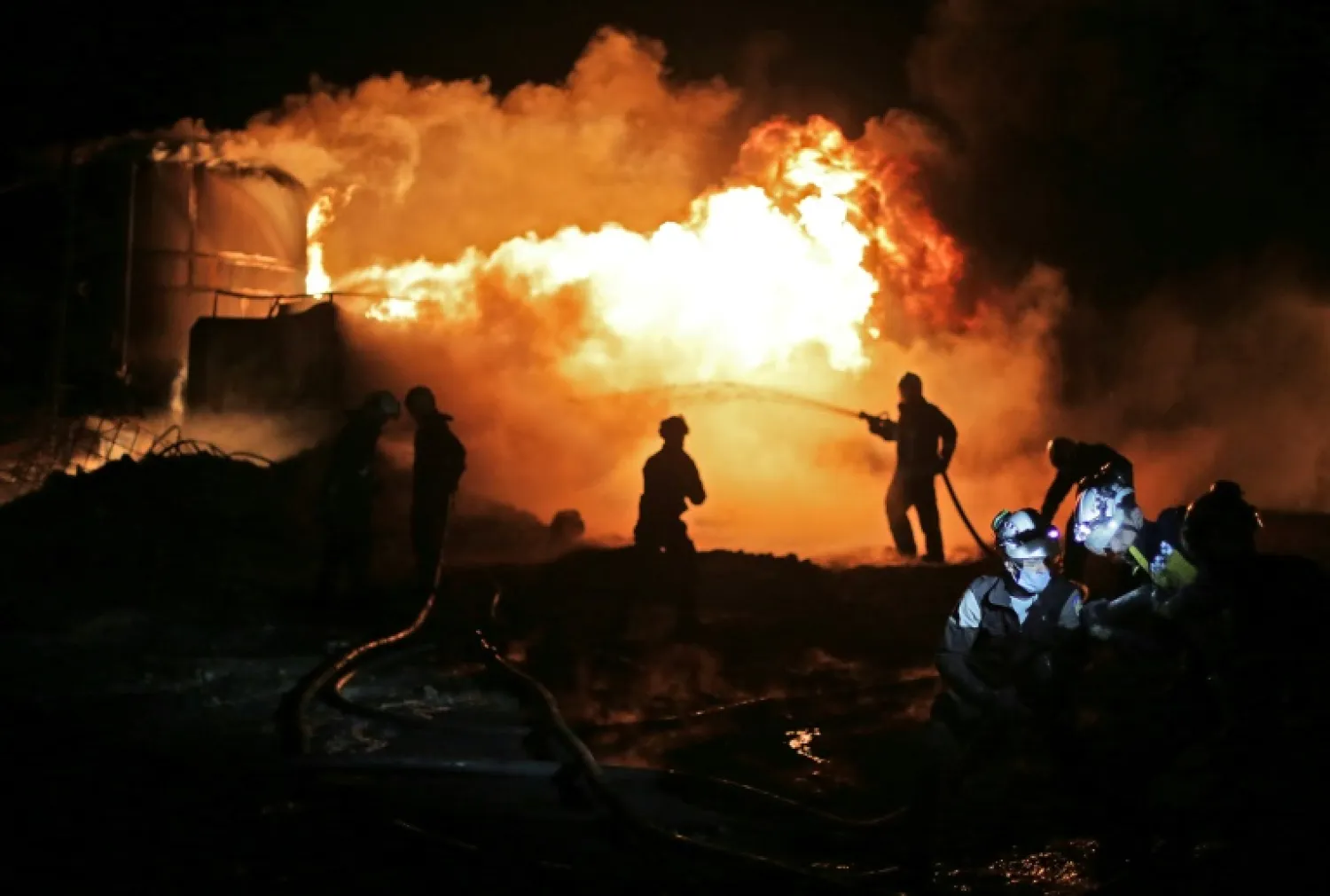 Syrian civil defense members (White Helmets) fight a fire that erupted after a bombardment of makeshift oil refining installations in an area of Turkish-controlled Aleppo province in northern Syria | AFP
