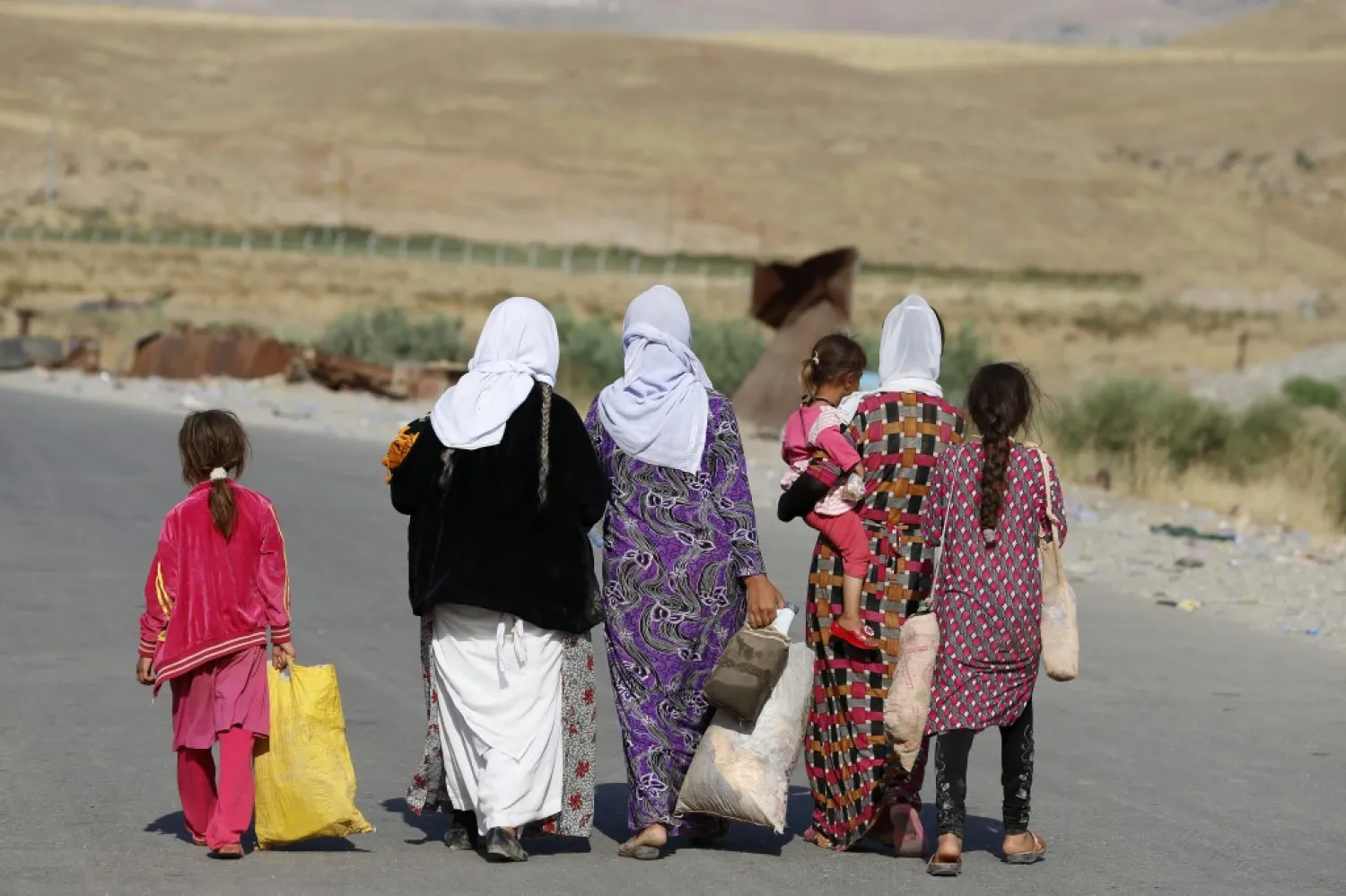 Women and children from the Yazidi sect, fleeing the violence in the Iraqi town of Sinjar, near the Iraqi-Syrian border crossing in Fishkhabour, Dohuk province, August 14, 2014. REUTERS/Youssef Boudlal

