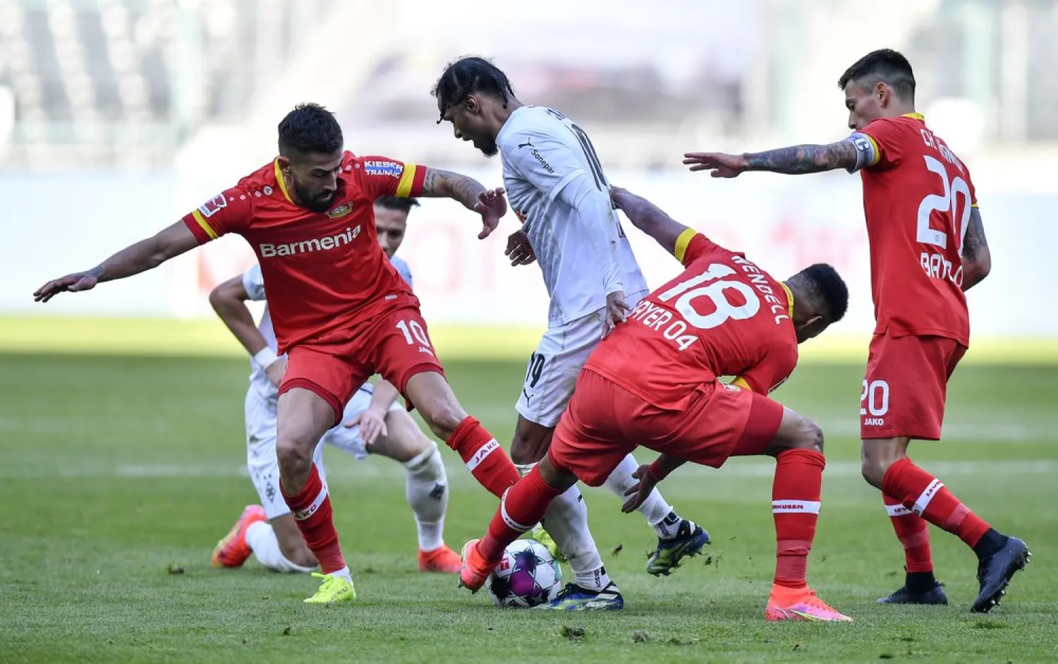Leverkusen's Kerem Demirbay, Moenchengladbach's Valentino Lazaro, Leverkusen's Wendell and Leverkusen's Charles Aranguiz, from left, challenge for the ball during the match. (AP)