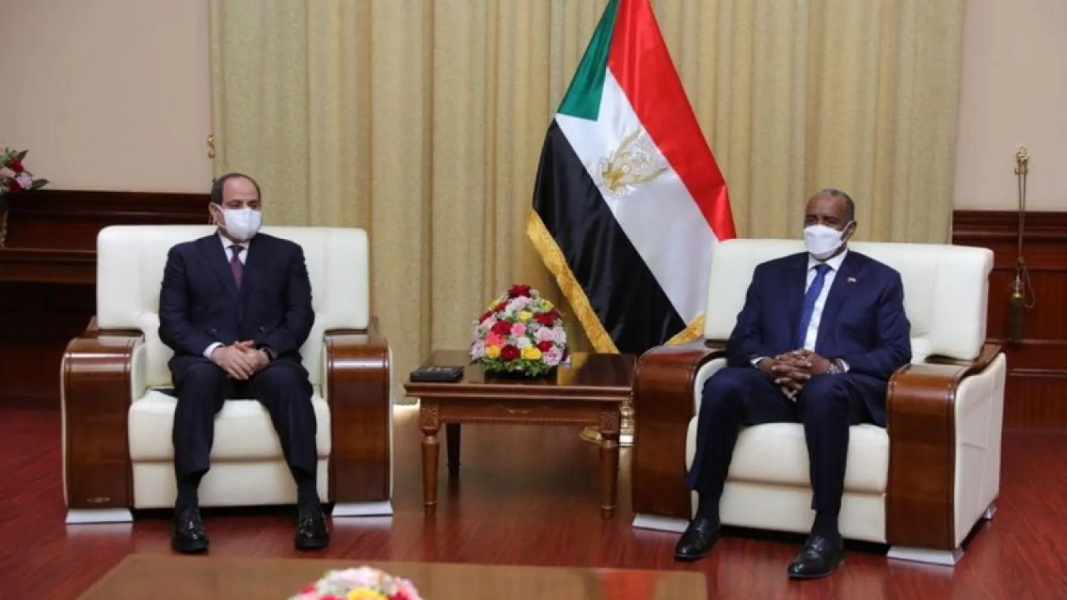President Sisi, left, meets with Abdel Fattah al-Burhan, head of the ruling Sovereign Council, at the presidential palace in Sudan. (Sudan Sovereign Council via Reuters)