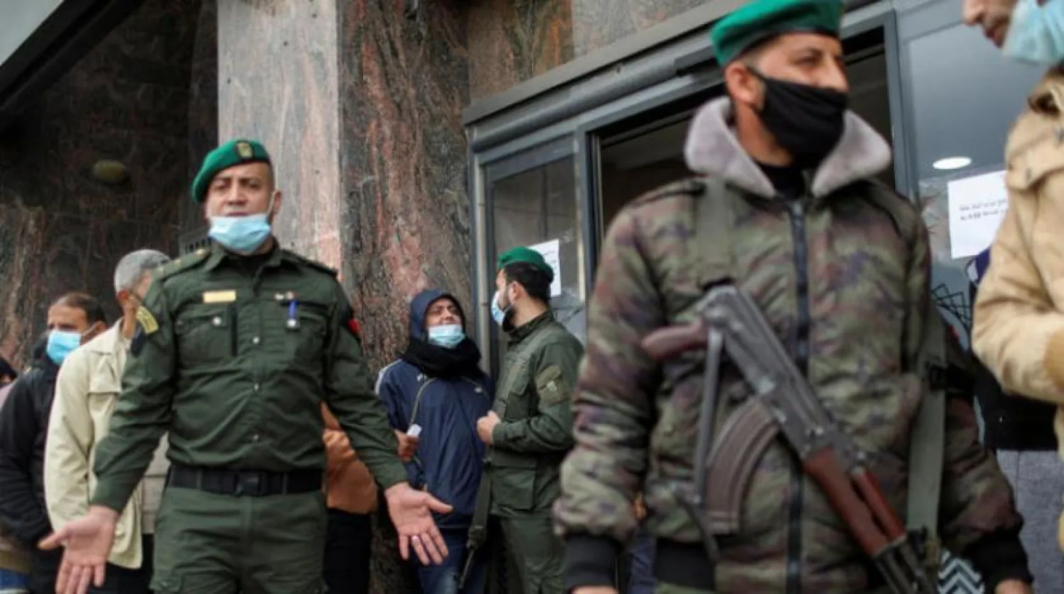 Policemen guard a bank as Palestinian Authority employees receive their salaries in Gaza City. Reuters file photo