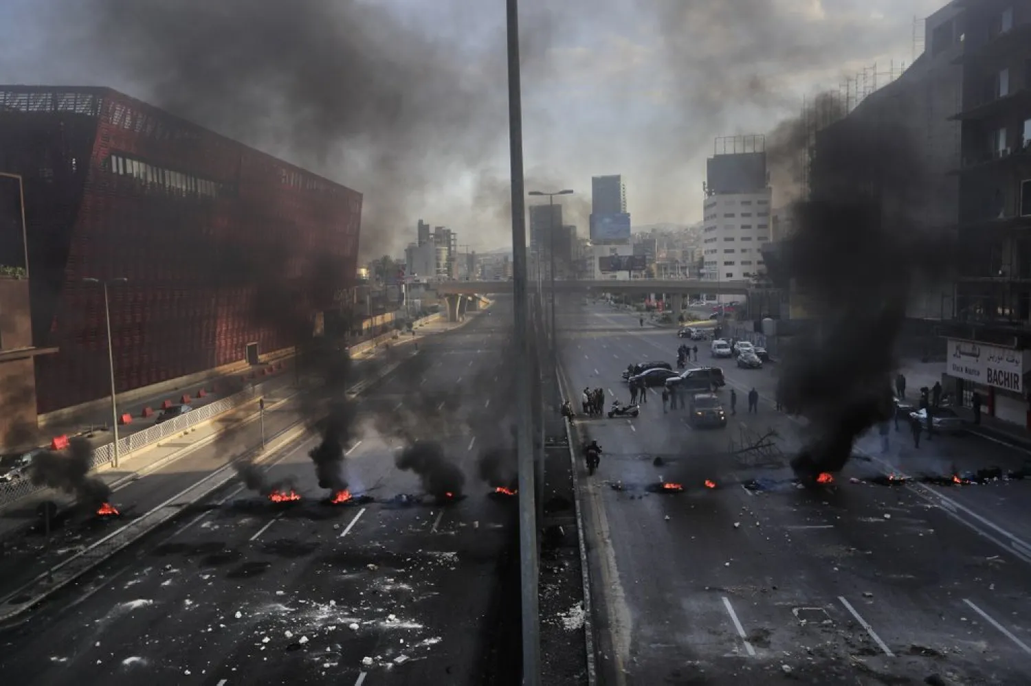 Black smoke rise from burned tires set by protesters to block a main highway, during a protest in the town of Jal el-Dib, north of Beirut, Lebanon, Monday, March 8, 2021. (AP)
