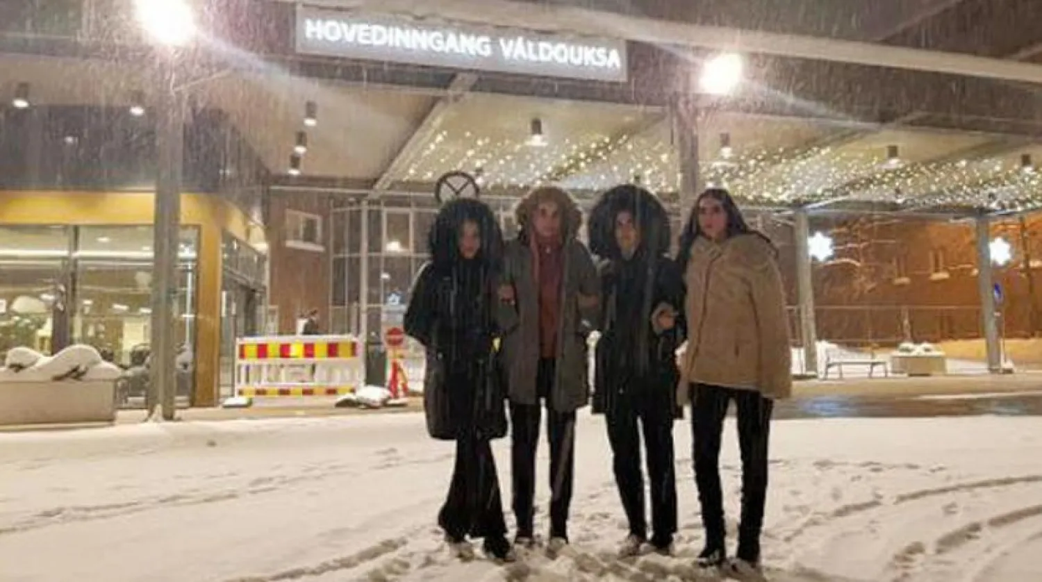 The women pose in front of the university hospital.