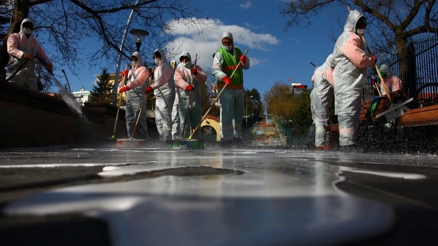 Municipality workers in protective suits disinfect Kugulu Park due to coronavirus concerns, in Ankara, Turkey, on March 17, 2020. (Reuters)