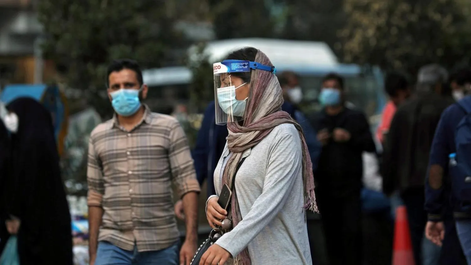 An Iranian woman wears a mask and face shield, amid a rise in coronavirus infections, in Tehran. Reuters file photo