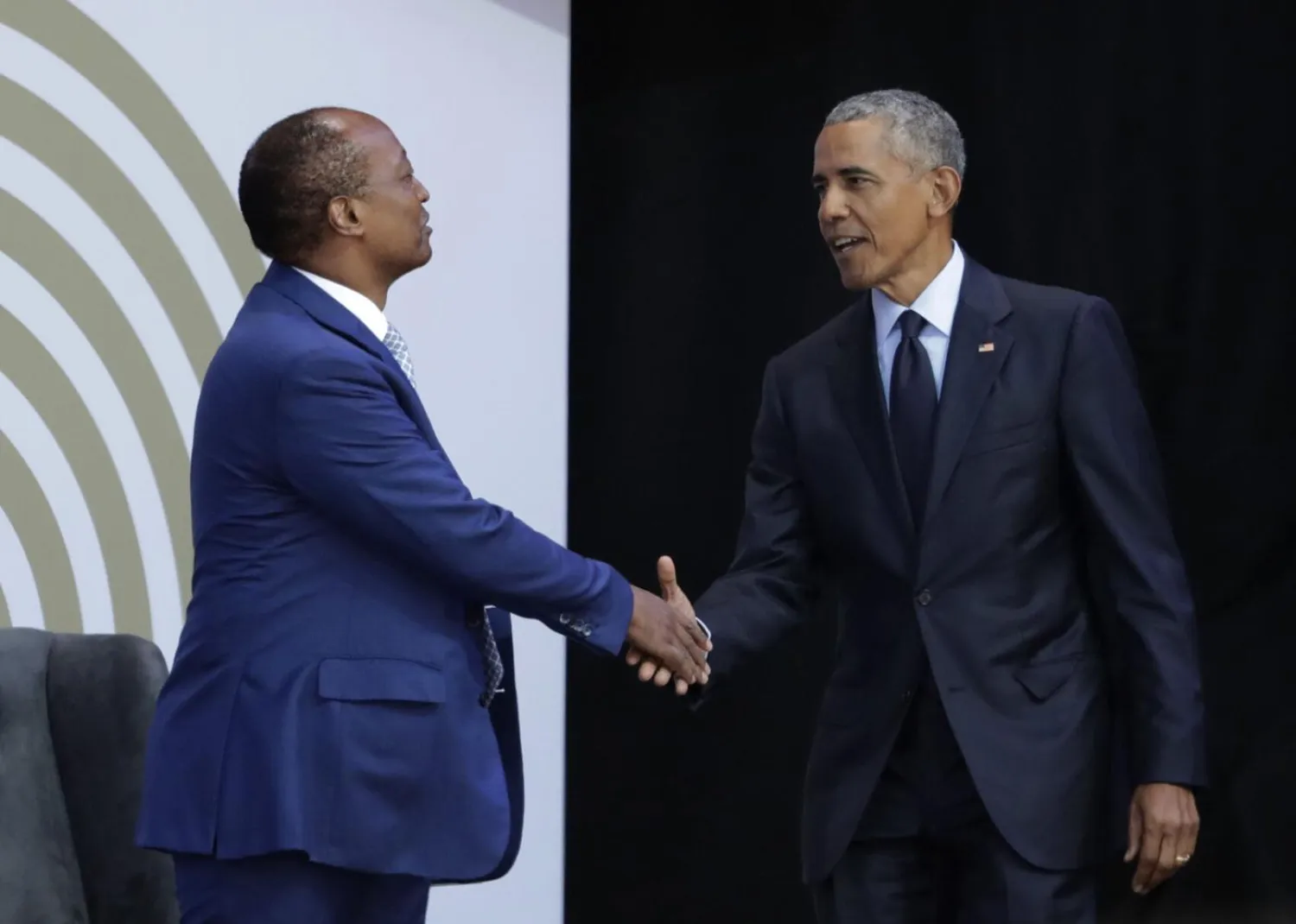 In this file photo dated Tuesday, July 17, 2018, former US President Barack Obama, right, shakes hands with Patrice Motsepe, as he arrives at the Wanderers Stadium in Johannesburg, South Africa, to deliver the 16th Annual Nelson Mandela Lecture. (AP Photo/Themba Hadebe, FILE)
