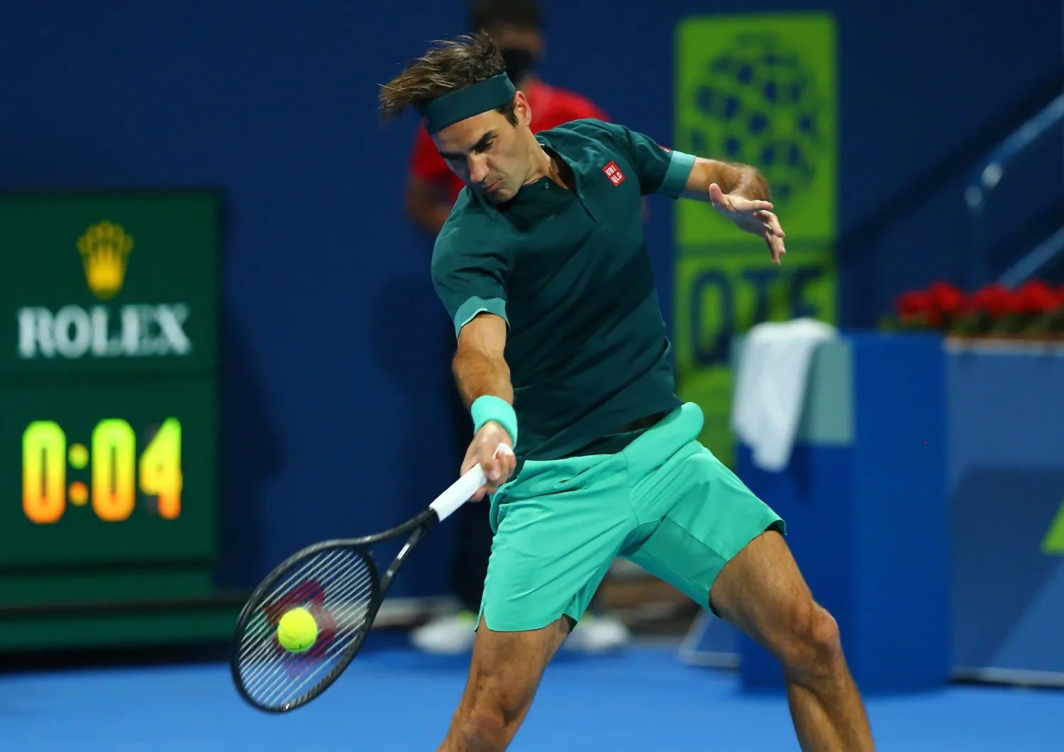 A handout photo made available by beIN Sports of Roger Federer of Switzerland playing a forehand against Daniel Evans of Great Britain during their match at the Qatar Exxonmobil Open in Doha, Qatar, 10 March 2021. (EPA handout by beIN Sports)
