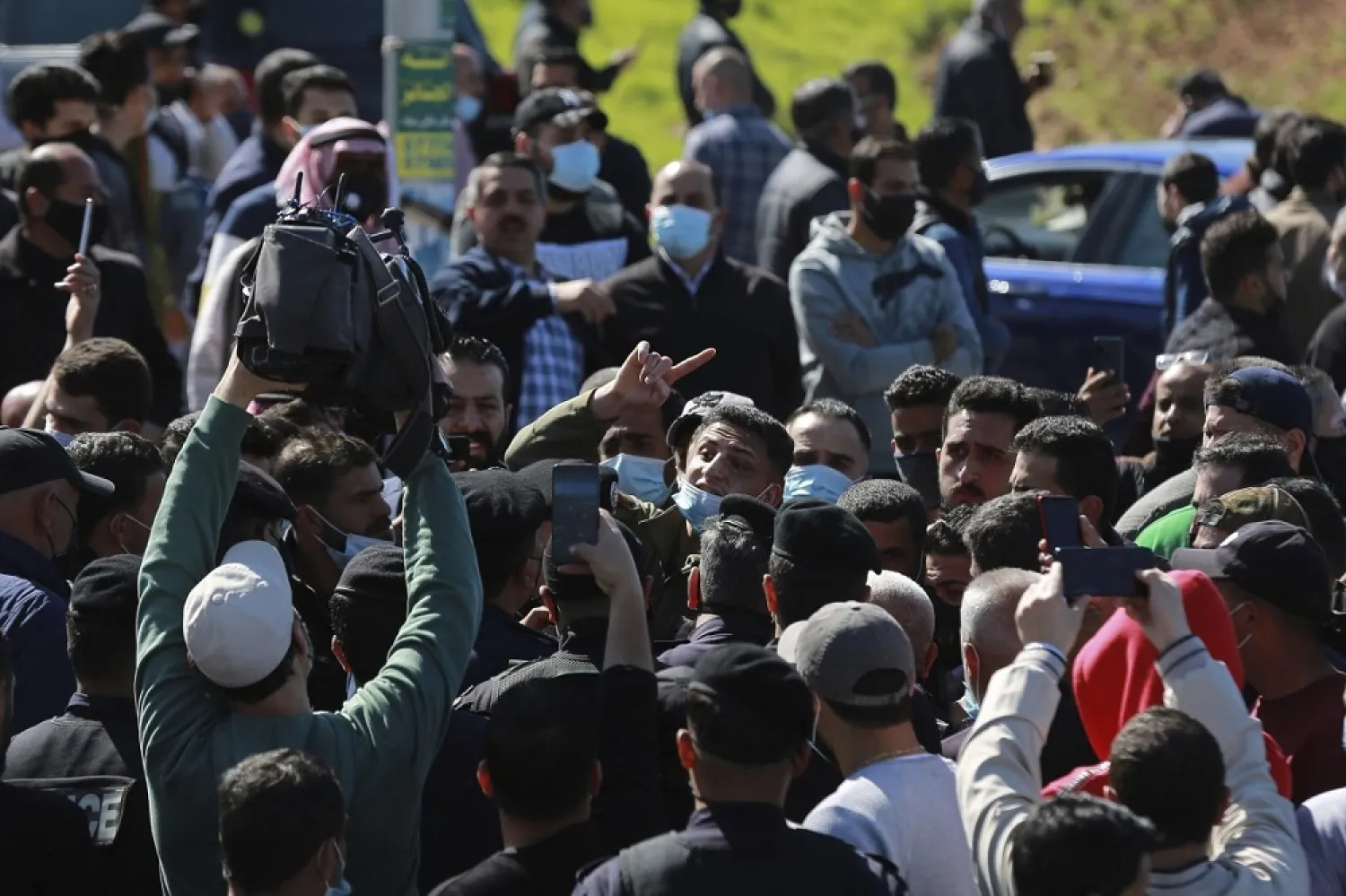 Angry people gather outside Al-Hussein New Salt Hospital in Salt, Jordan on Saturday. (AP)