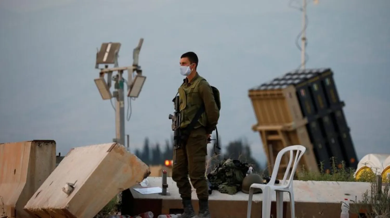 An Israeli soldier stands guard next to an Iron Dome anti-missile system near the Israel's northern border with Lebanon, July 27, 2020. (Reuters)
