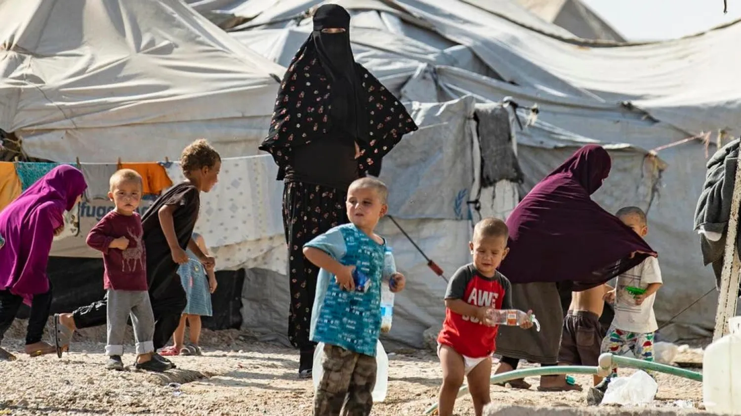 Women look after children at the Kurdish-run al-Hol camp for the displaced where families of ISIS foreign militants are held, in the al-Hasakah governorate in northeastern Syria, on October 17, 2019. (AFP)
