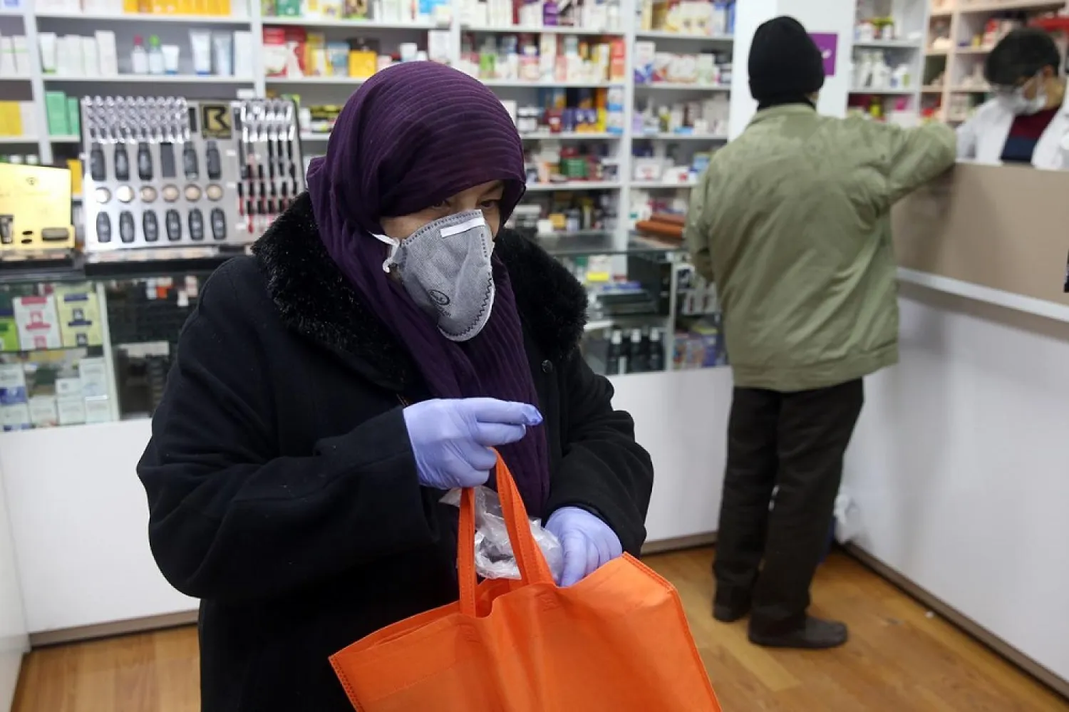 An Iranian woman wears a protective mask to prevent contracting coronavirus, and she is seen at a drug store in Tehran on February 25, 2020. (Reuters)