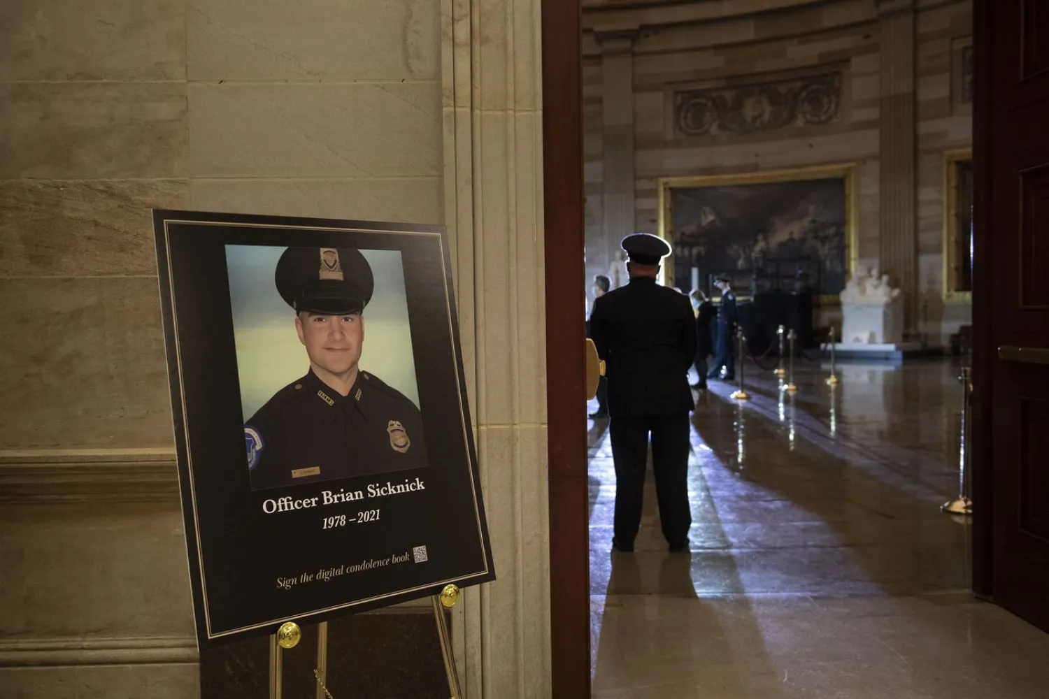 A placard is displayed with an image of the late US Capitol Police officer Brian Sicknick as people wait for an urn with his cremated remains to be carried into the US Capitol to lie in honor in the Rotunda in Washington on Feb. 2.Read more
Brendan Smialowski / AP