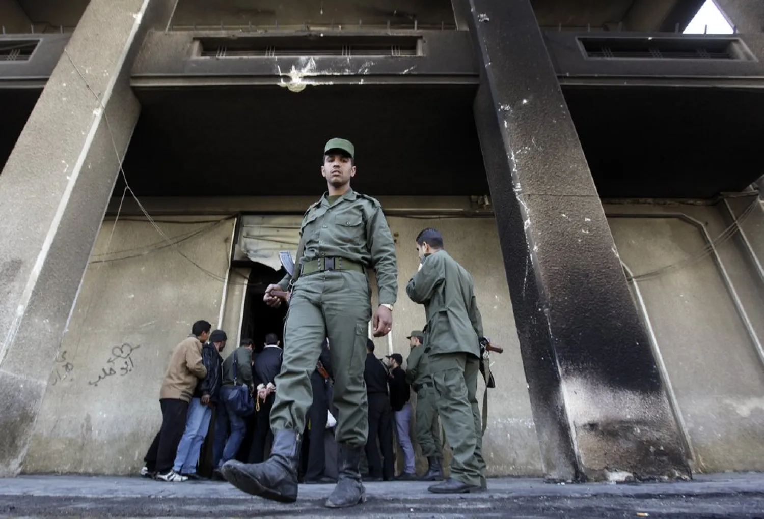 In this March 21, 2011, file photo, a Syrian soldier steps out of the burned courthouse that was set on fire by anti-government protesters in the southern city of Daraa, Syria. (AP)