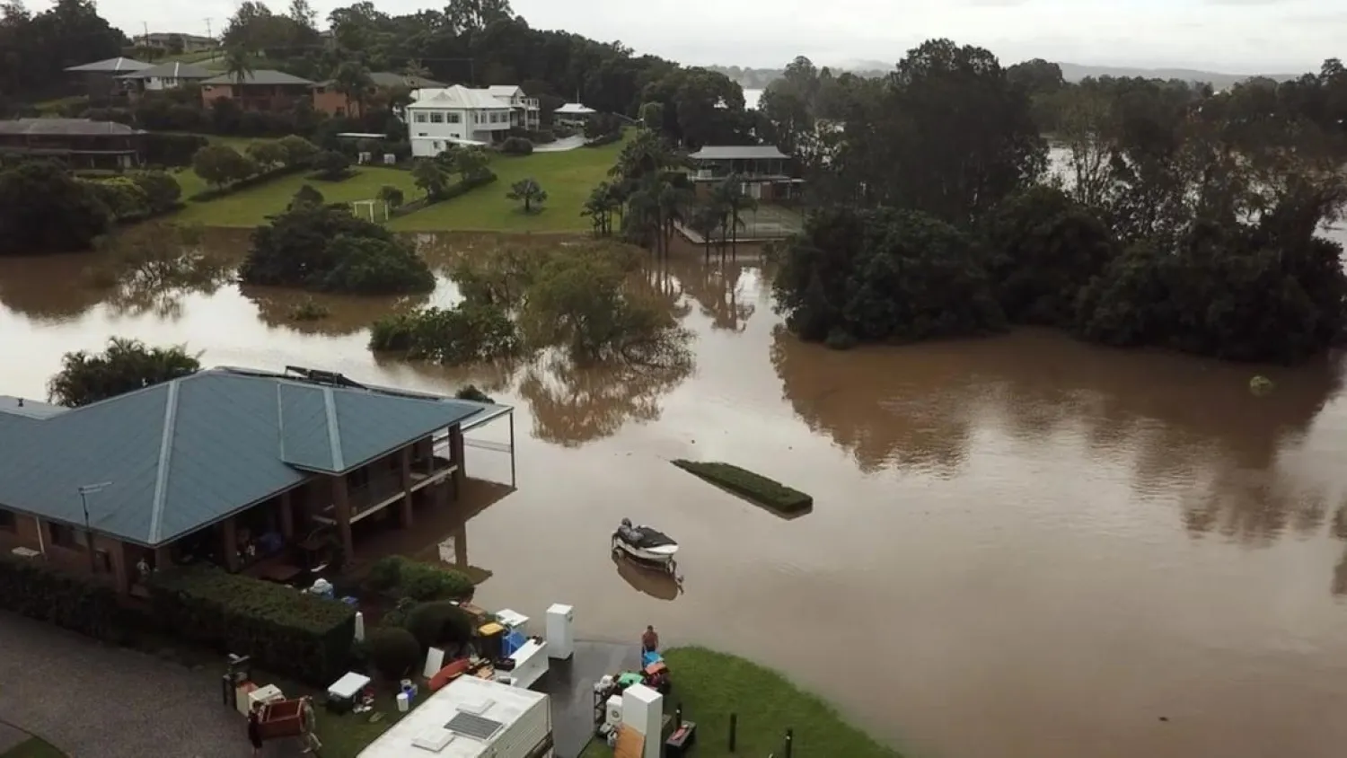 People move their belongings during floods after heavy rainfall in Tinonee, New South Wales. (Reuters)