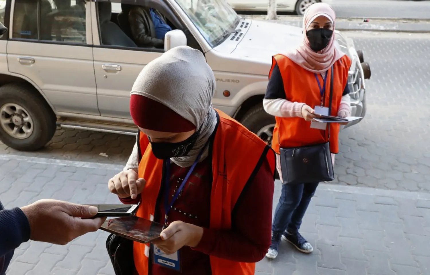 In this Feb. 10, 2021 file photo, poll workers from the Central Elections Commission register a local resident to the electoral roll, on the main road of Gaza City. (AP)