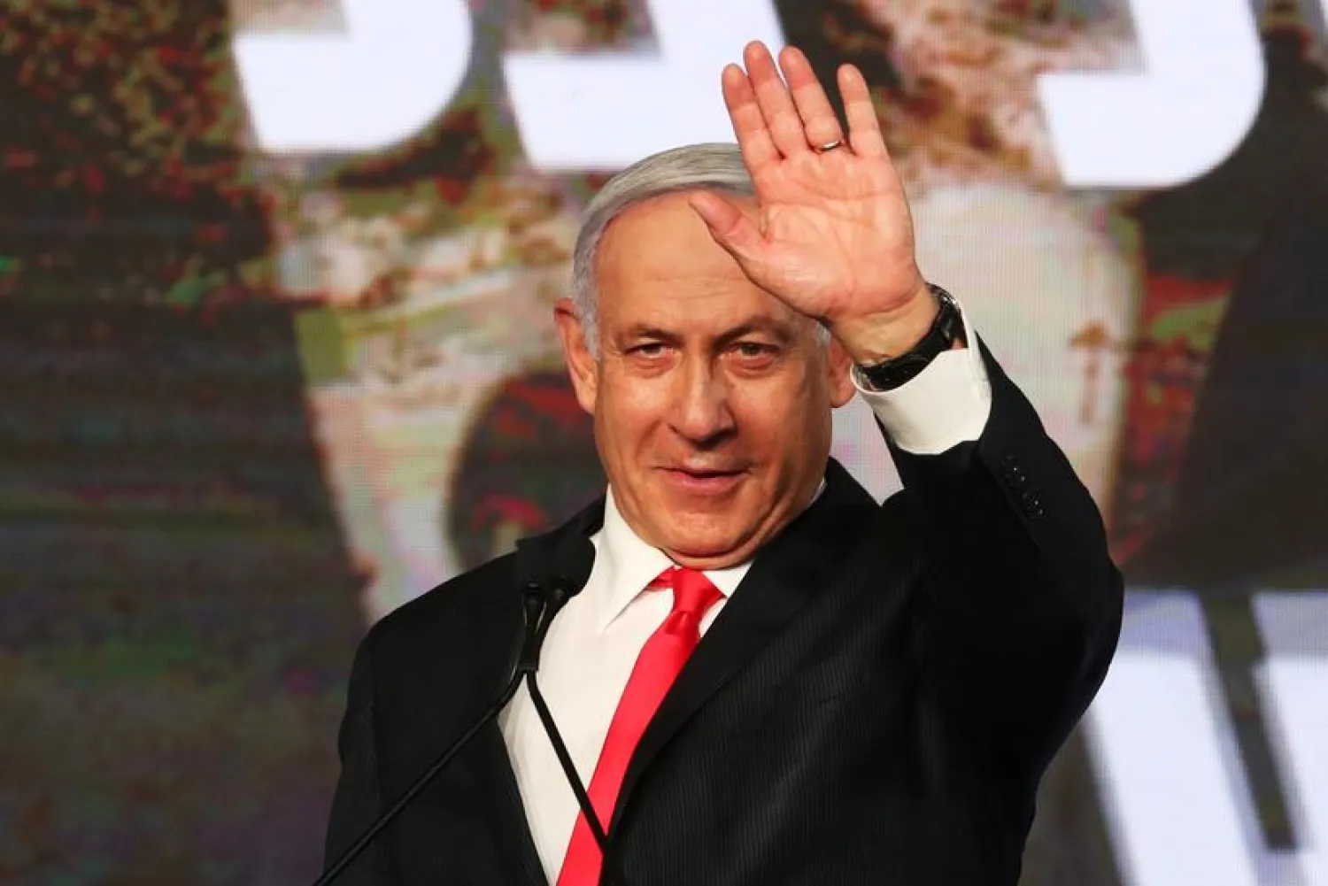 Israeli Prime Minister Benjamin Netanyahu gestures as he delivers a speech to supporters following the announcement of exit polls in Israel's general election at his Likud party headquarters in Jerusalem March 24, 2021. REUTERS/Ammar Awad