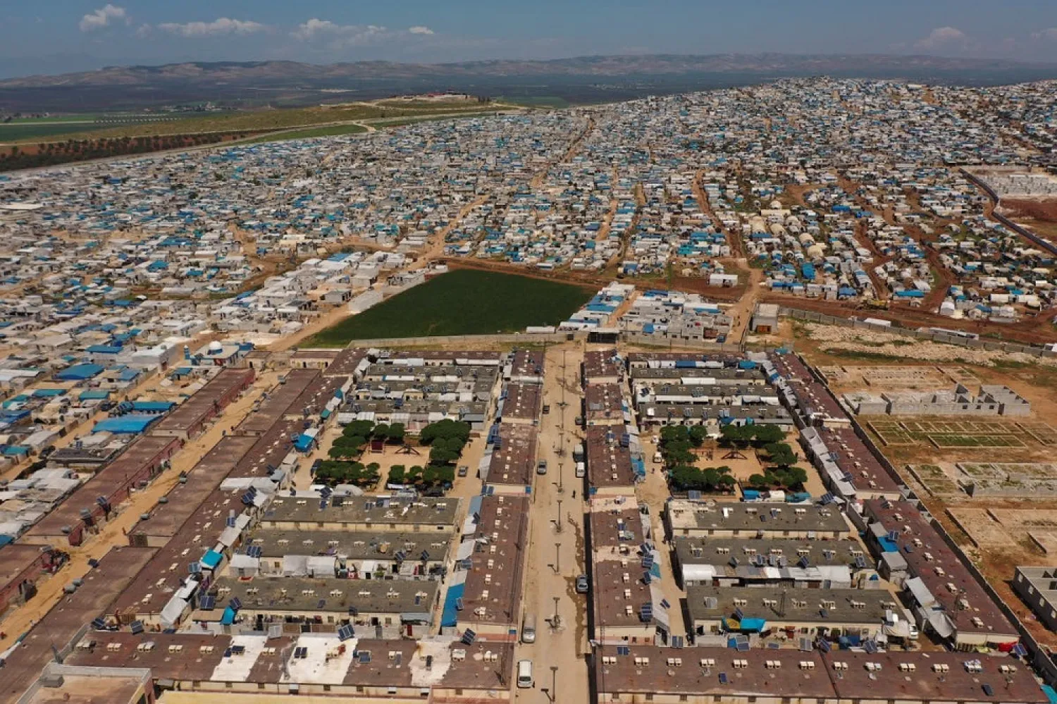 In this April 19, 2020 file photo, shows a large refugee camp on the Syrian side of the border with Turkey, near the town of Atma, in Idlib province, Syria. (AP)