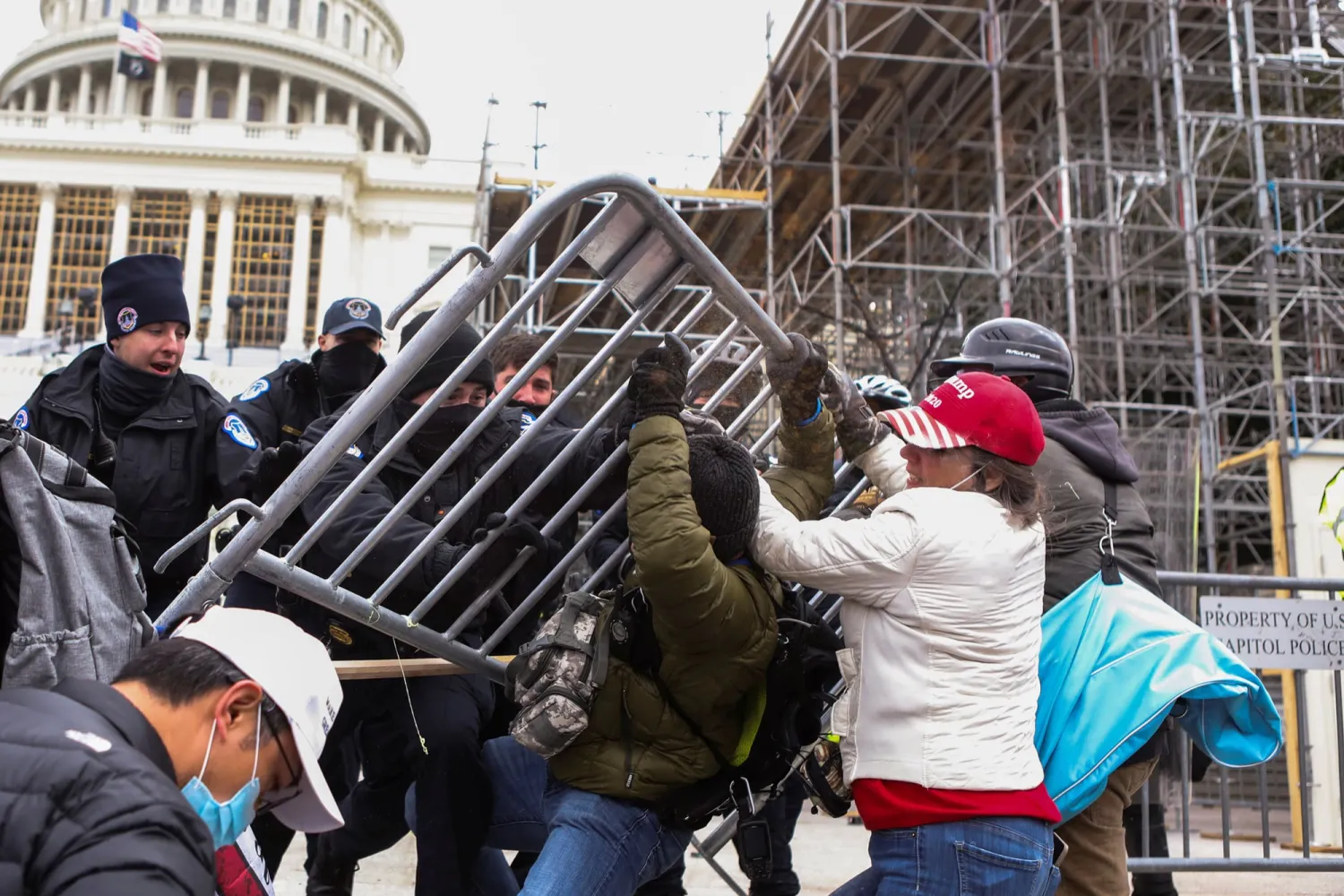 Pro-Trump rioters attempt to tear down a police barricade during the January 6 insurrection. REUTERS/Jim Urquhart