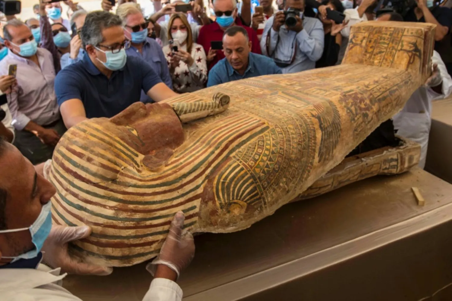 Egypt continues to unearth ancient remains - - this photograph from October 2020 shows the opening of a sarcophagus excavated by the Egyptian archaeological mission at the Saqqara necropolis near Cairo - AFP