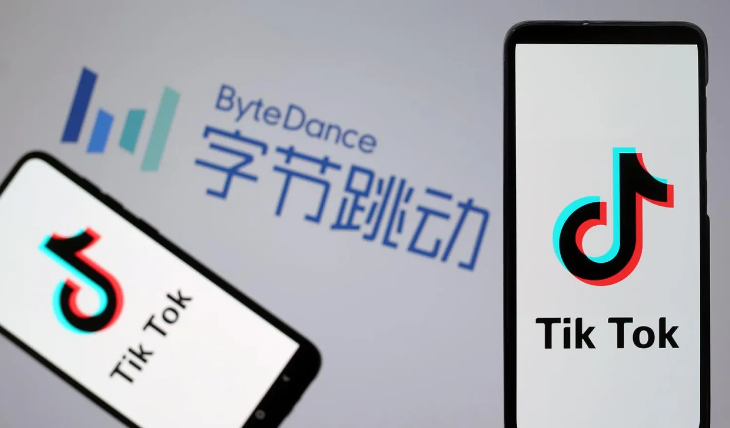 Tik Tok logos are seen on smartphones in front of a displayed ByteDance logo in this illustration taken November 27, 2019. REUTERS/Dado Ruvic/Illustration