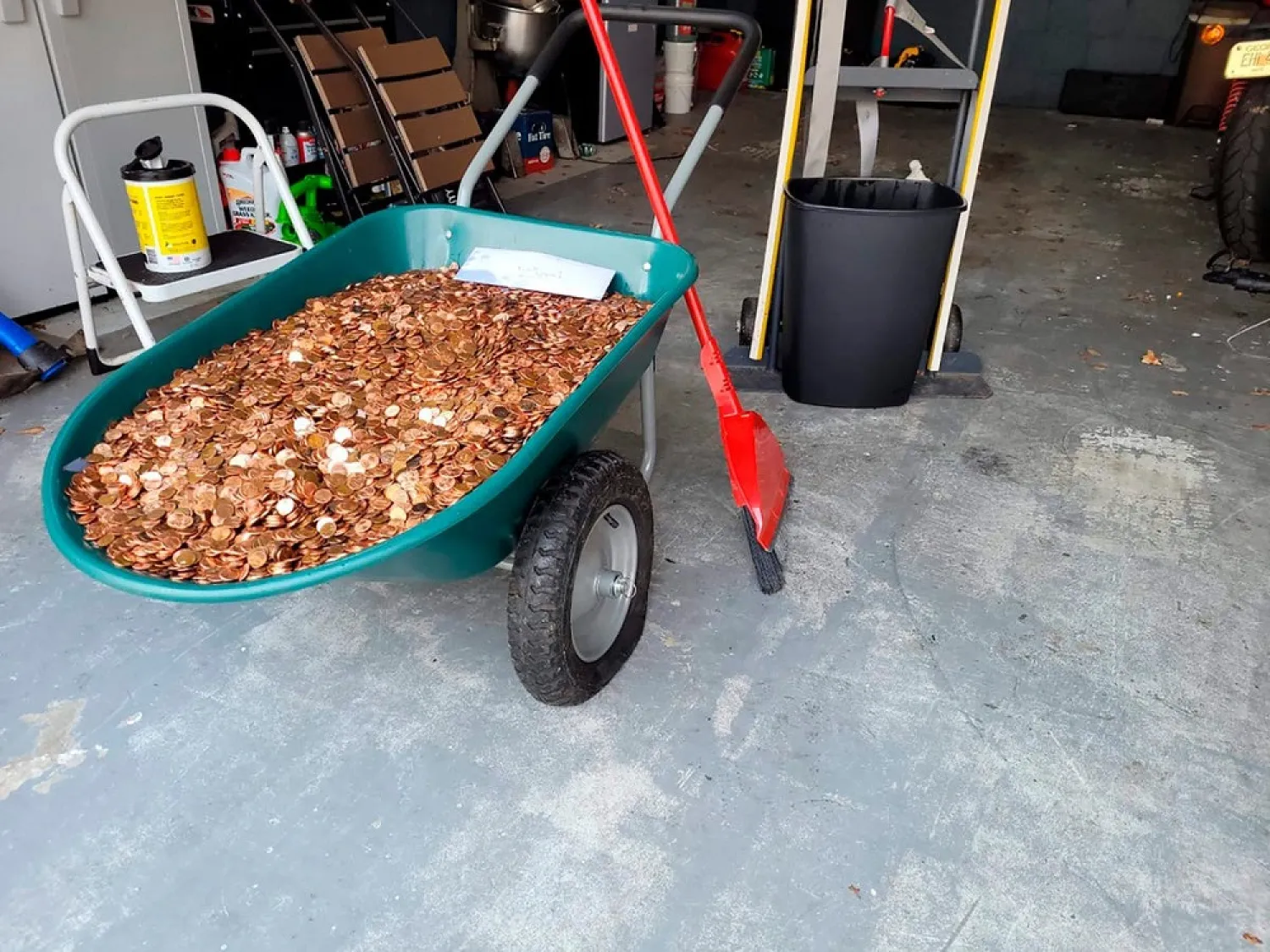 This image provided by Olivia Oxley shows a wheelbarrow filled with pennies, March 20, 2021 in Fayetteville, Ga. (AP)