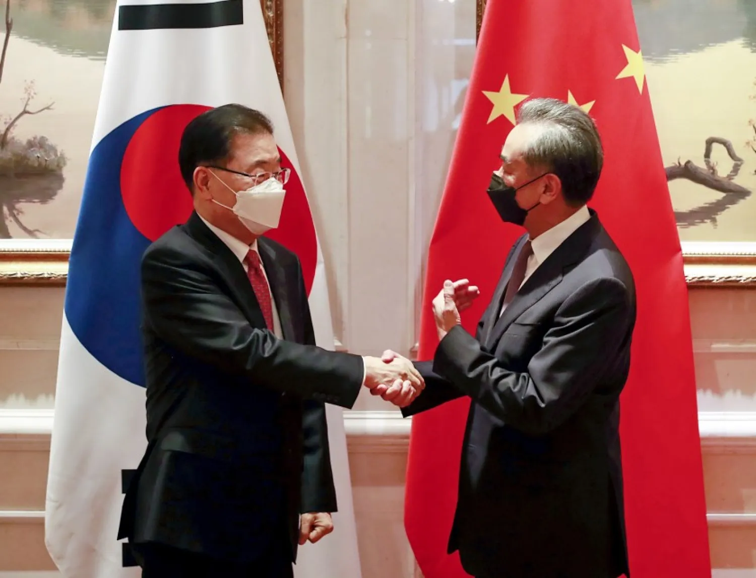 South Korean Foreign Minister Chung Eui-yong, left, shakes hands with Chinese Foreign Minister Wang Yi before their meeting in Xiamen, China, Saturday, April 3, 2021. (Kim Yun-gu/Yonhap via AP)(ASSOCIATED PRESS)
