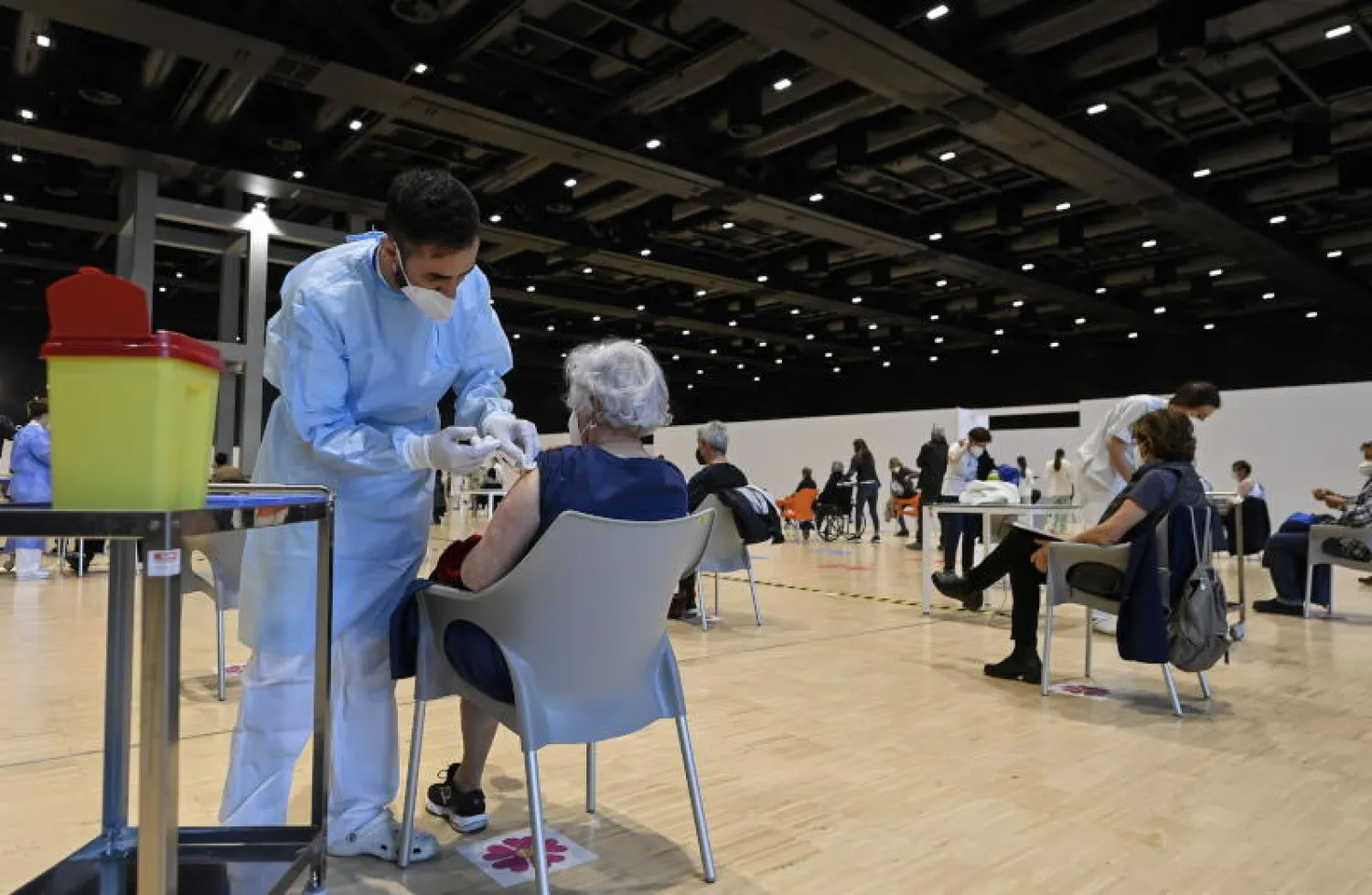 أشخاص يتلقون اللقاح في مركز تطعيم بروما (إ.ب.أ)