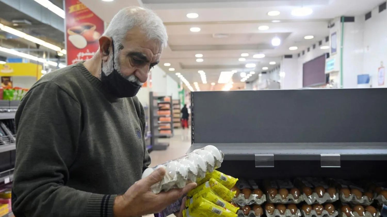 A customer looks at eggs price in a supermarket in Beirut, Lebanon. (EPA)