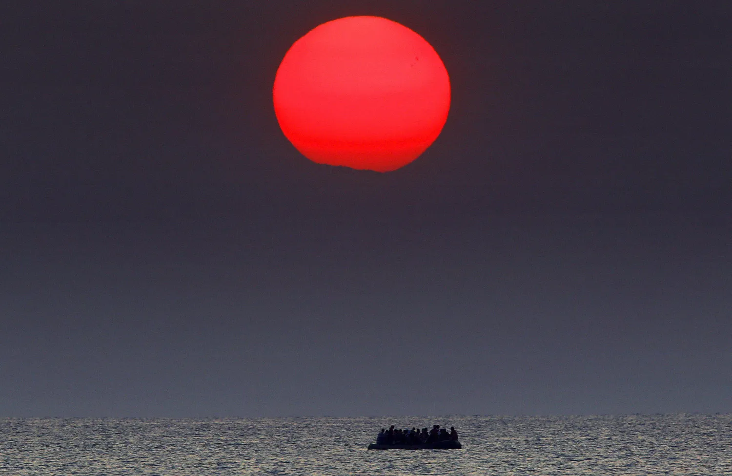 A dinghy overcrowded with Syrian refugees drifts in the Aegean sea between Turkey and Greece after its motor broke down off the Greek island of Kos on August 11, 2015. Yannis Behrakis / Reuters