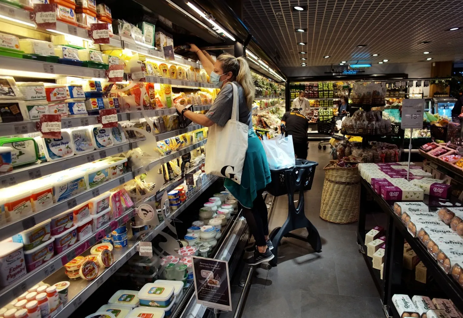 People wearing face masks for protection during the coronavirus outbreak shop for food at a market, Ankara, Turkey, May 22, 2020. (AP)