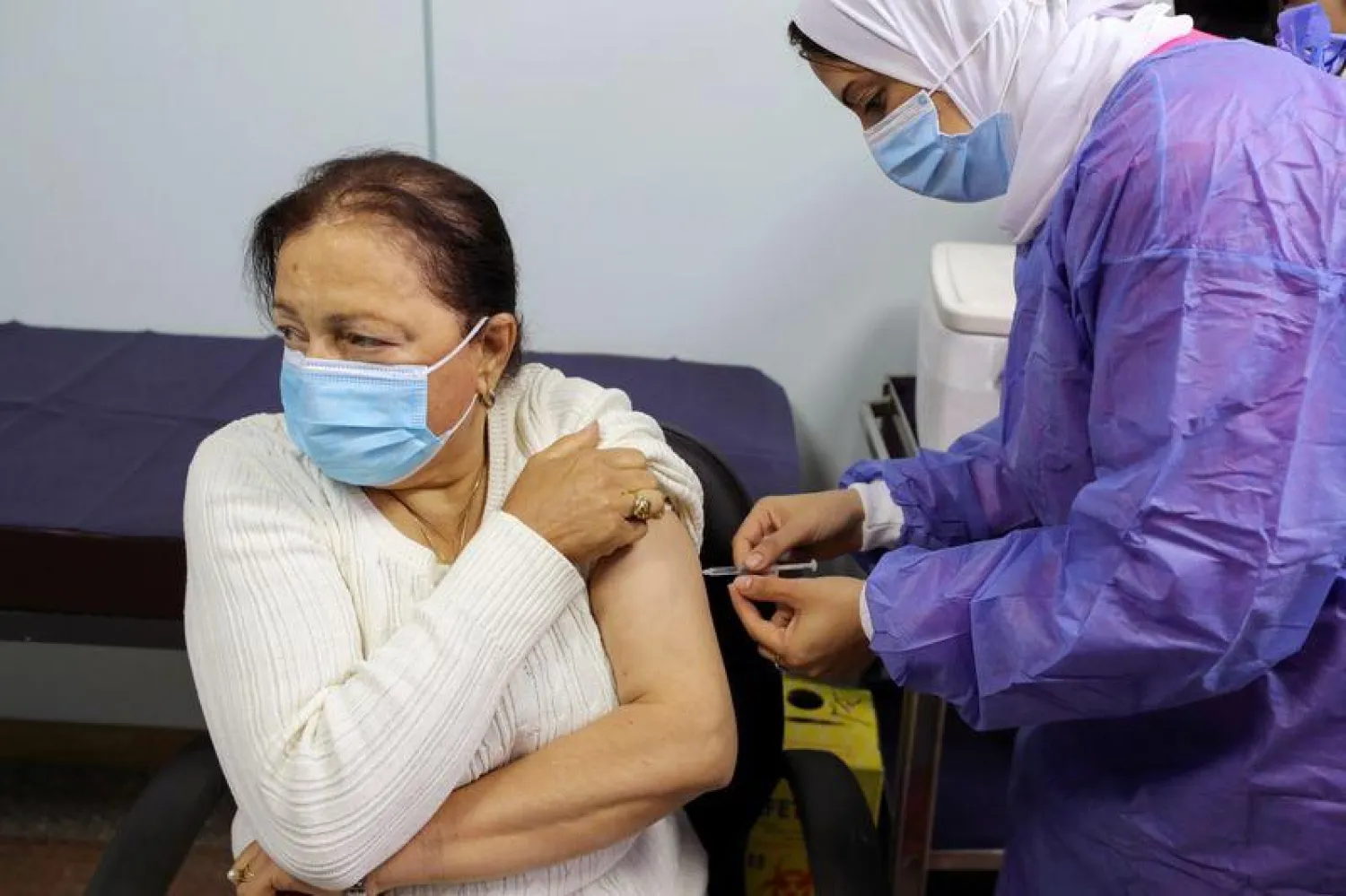 A woman receives a dose of a vaccine against the coronavirus disease (COVID-19) in Cairo, Egypt March 4, 2021. REUTERS/Mohamed Abd El Ghany
