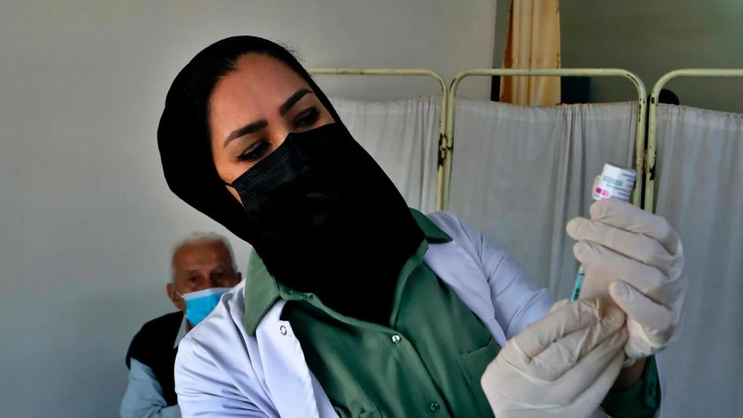 A nurse prepares a Covid-19 vaccine at a clinic in Baghdad. (AP)