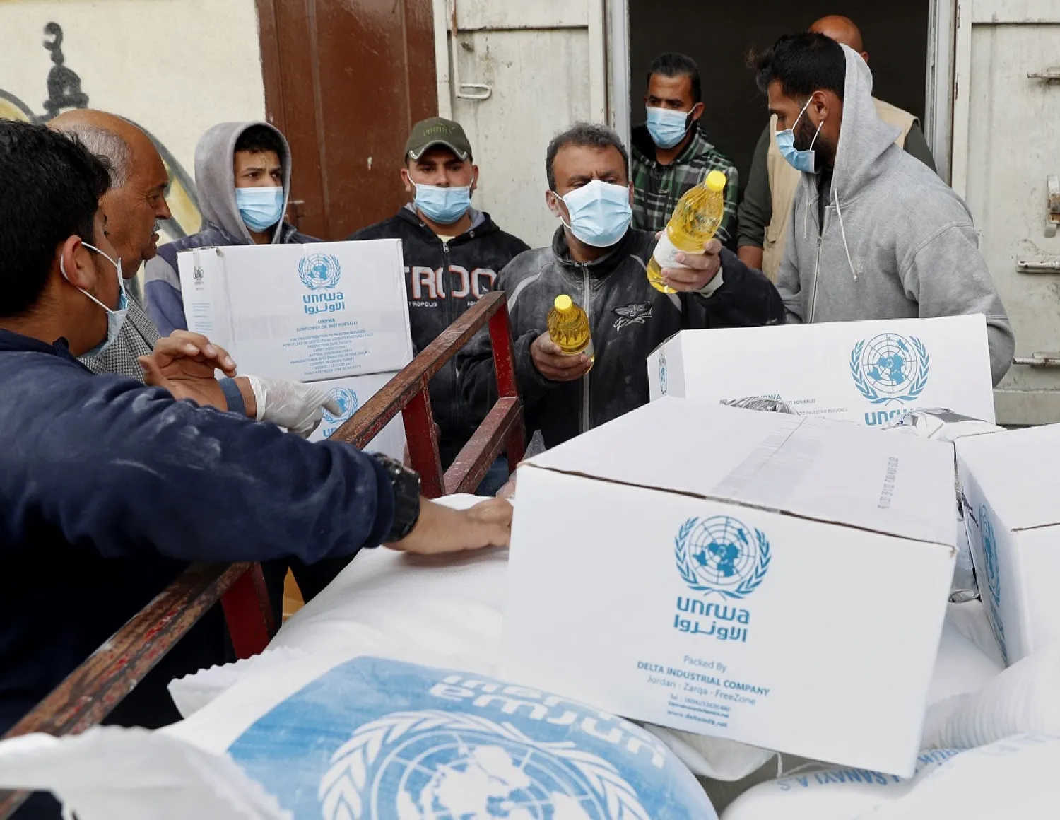 In this March 31, 2020 file photo, Palestinian workers load food supplies distributed by UNRWA at the Sheikh Redwan neighborhood of Gaza City. (AP)